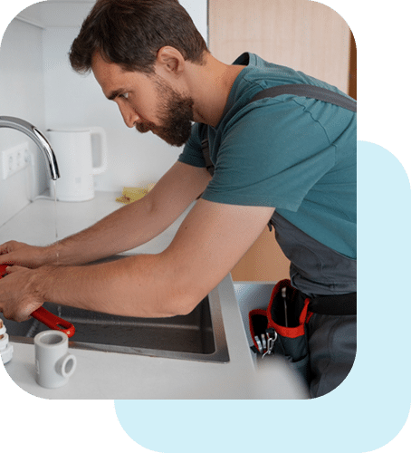 a person working on a sink